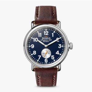 Shinola Argonite-1069 watch features a blue dial and brown leather strap for timeless style.